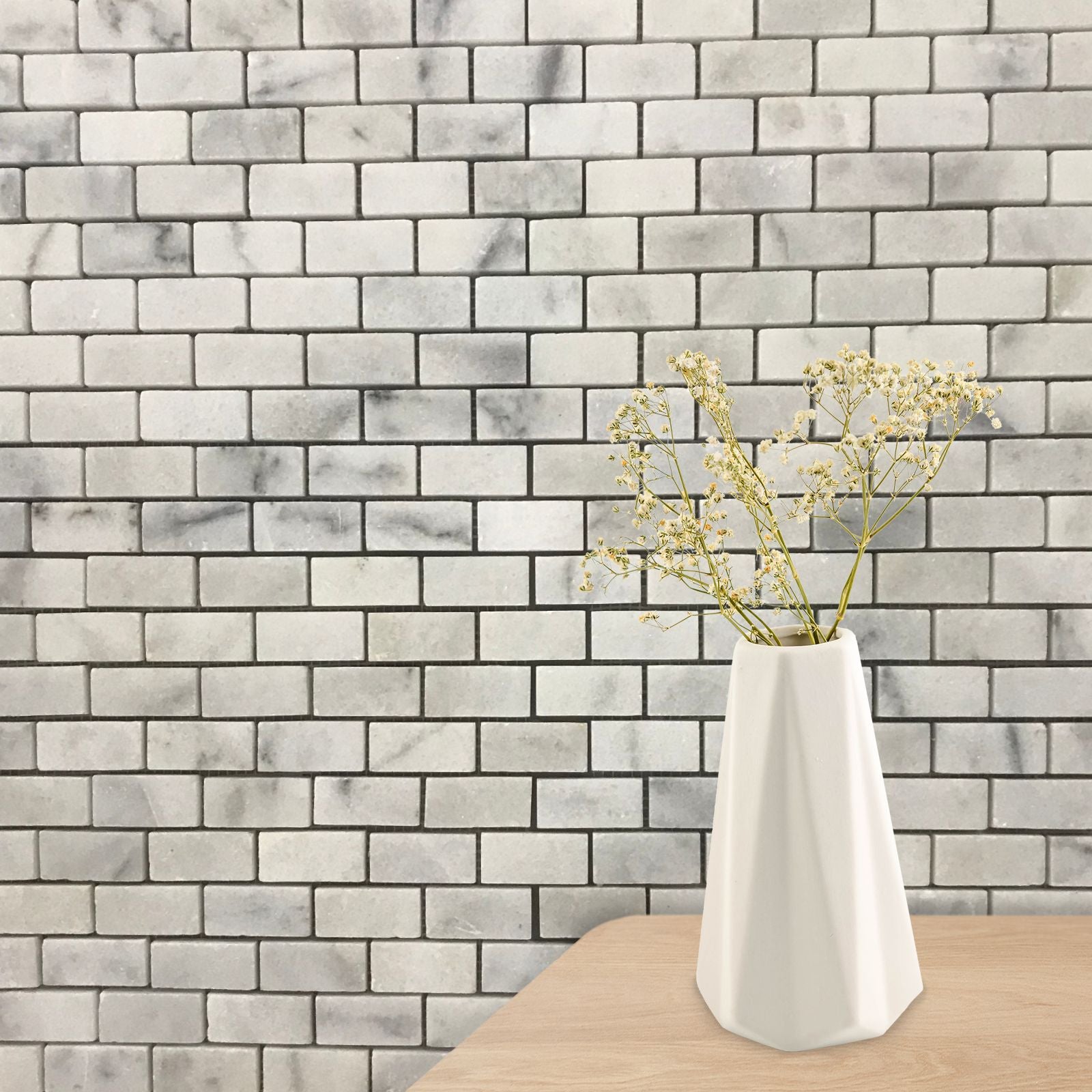 Close detail of polished Carrara marble bricks showing the veining and glossy surface