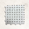 White marble basketweave mosaic tile with woven pattern featuring rectangular pieces and grey marble accents