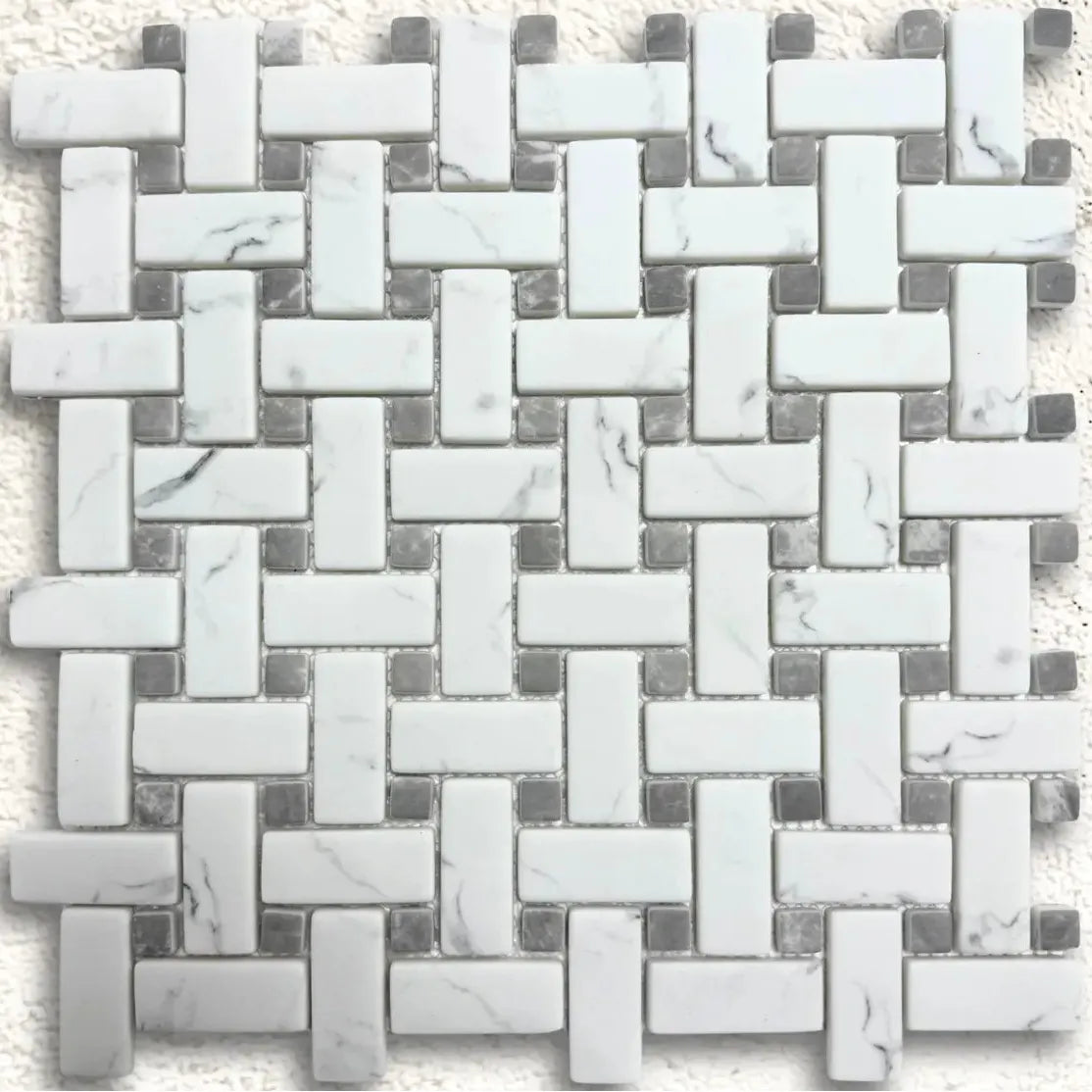 White marble basketweave mosaic tile with woven pattern featuring rectangular pieces and grey marble accents