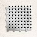 White marble and black mosaic tile in a woven basketweave pattern for ritz carrara mosaic design
