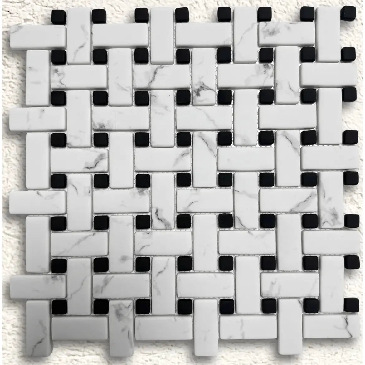 White marble and black mosaic tile in a woven basketweave pattern for ritz carrara mosaic design