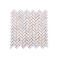 Sheet of Calacatta Sugar tumbled marble herringbone mosaic showing gold and grey veining on white stone