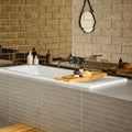 White rectangular bathtub with sleek modern design and smooth edges shown with 300mm brick antique mirror copper