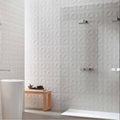 White textured wall tiles with a geometric three-dimensional diamond pattern in matt finish