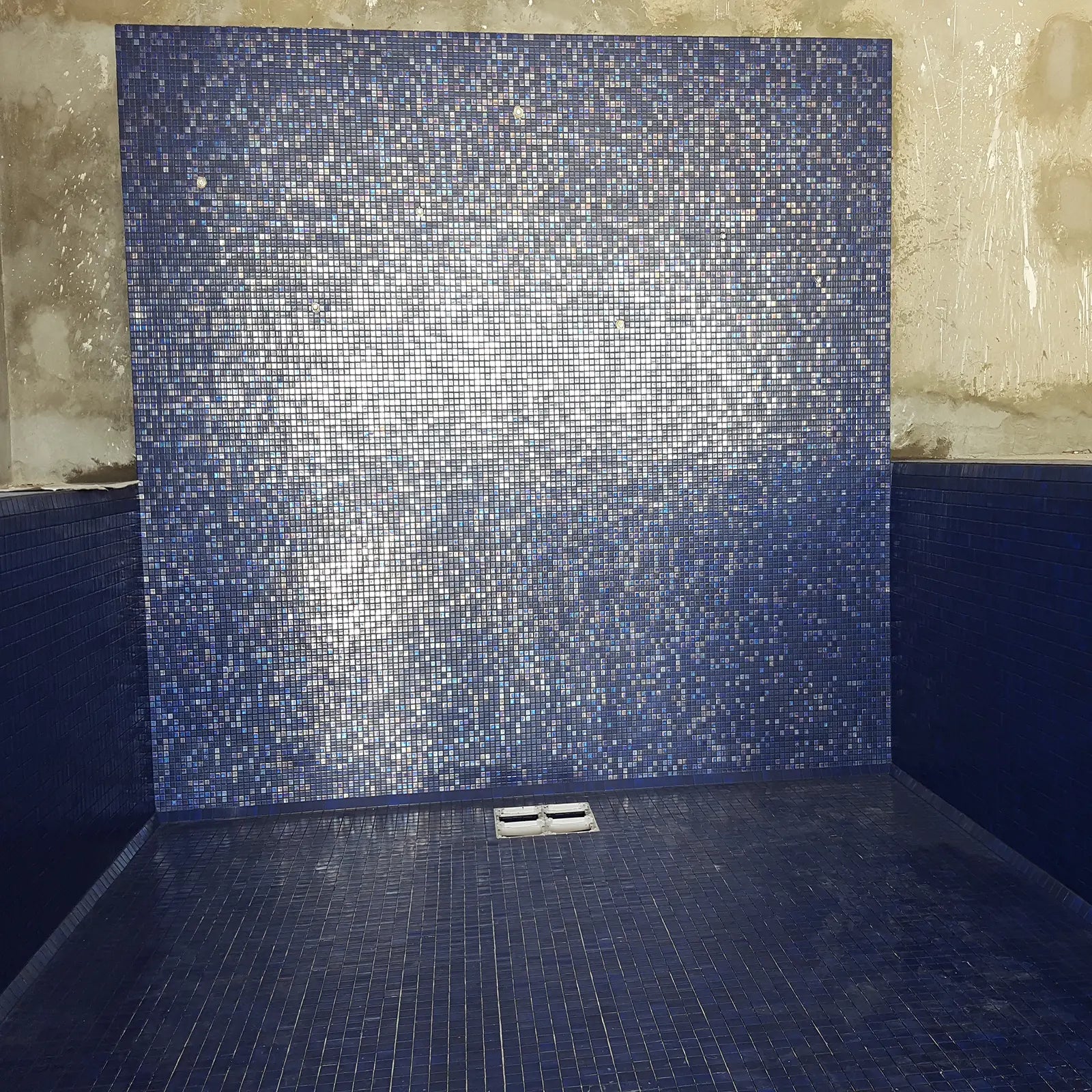 Abalon Azure blue glass mosaic tiles shown as a shower wall