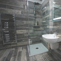 Origen Dark 15 x 90cm porcelain wood effect tile room setting