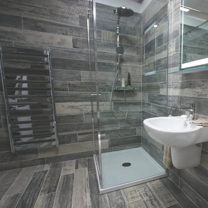 Origen Dark 15 x 90cm porcelain wood effect tile room setting