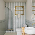 Remy Sage green gloss brick wall tile 6.5 x 13cm shown in a room setting