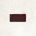 Remy Wine red gloss brick wall tile 6.5 x 13cm shown in a room setting