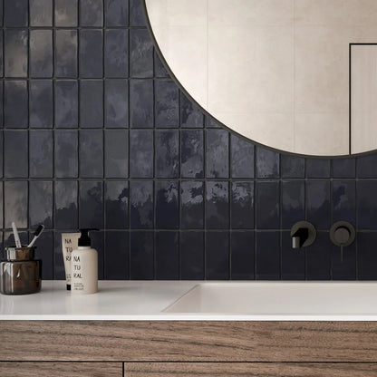 Remy French Navy gloss brick wall tile 6.5 x 13cm shown in a room setting