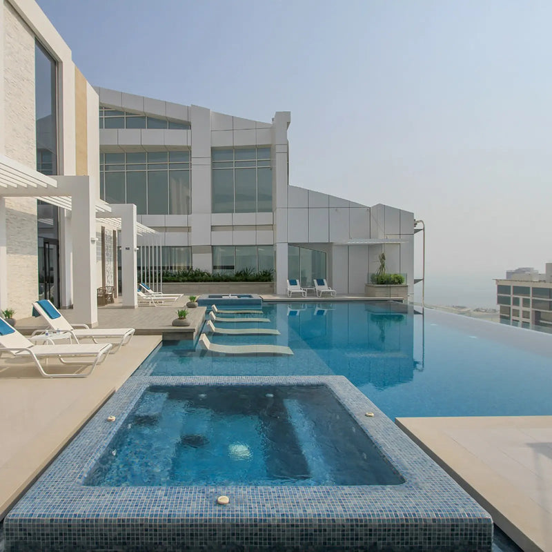 Aquastyle Blue Macauba glass mosaic tiles lining a swimming pool
