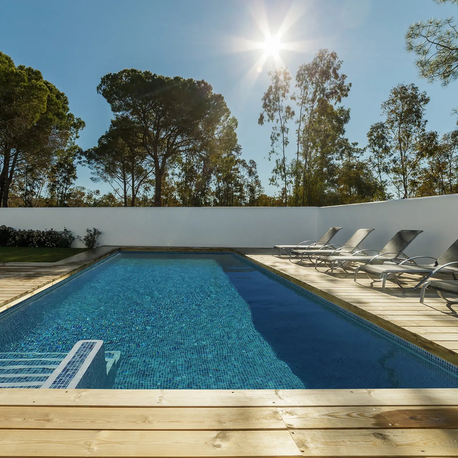Aquastyle Forest Blue glass mosaic tiles lining a swimming pool