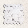 White hexagonal marble mosaic tile with subtle gray veining in hex xl fosco matte mosaic design