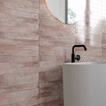 Genesi Pink Brillo 4.8 x 45cm pink gloss brick tiles in a room setting