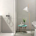 Modern bathroom with a shower, sink, and small table with decor items.