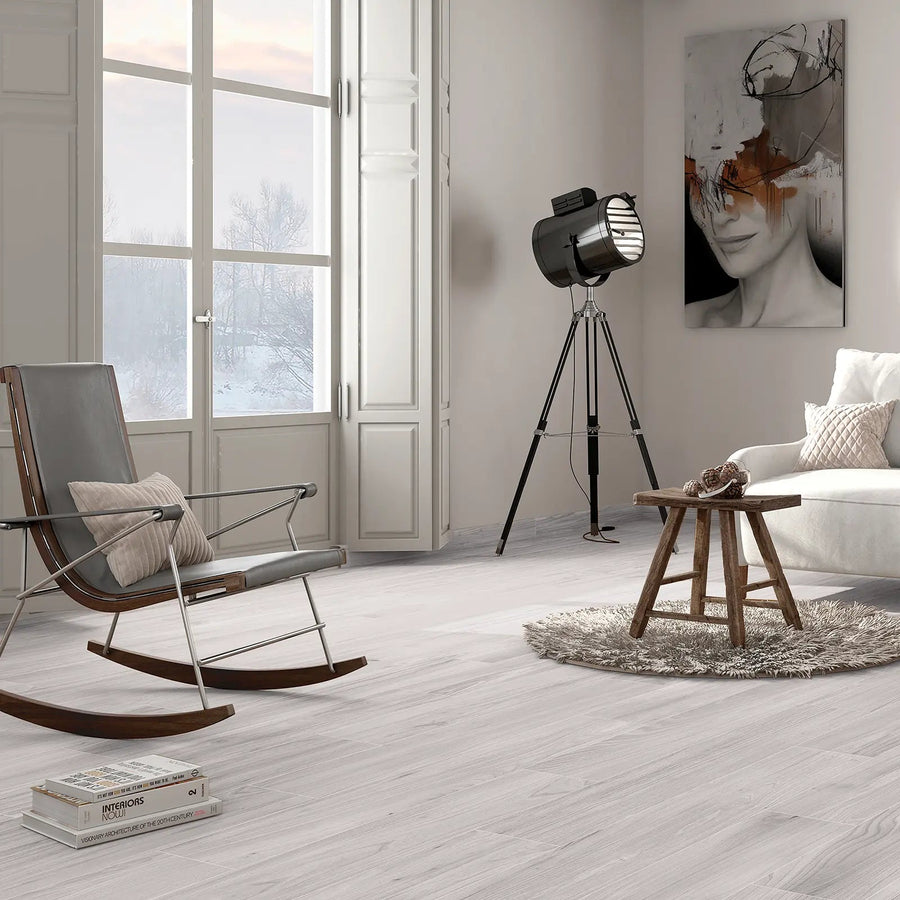 Aire Blanco 20x120cm pale grey wood effect porcelain plank flooring shown in an interior
