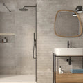 Modern bathroom with concrete walls, a sink, and a mirror.