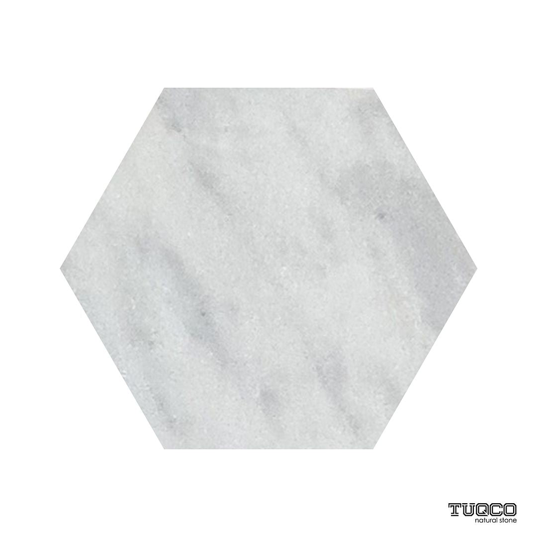 Honed Carrara marble hexagons laid as a bathroom floor in a honeycomb pattern