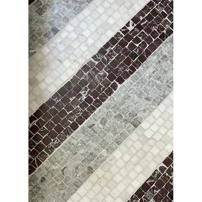 Close view of chipped rustic edges on honed Rosso Levanto red marble mosaic squares