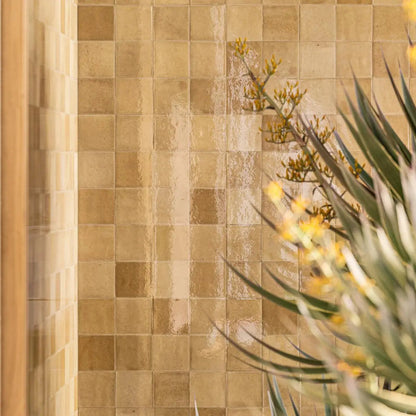 Taza Caramel 10 x 10cm ceramic zellige-style tiles shown on an interior wall