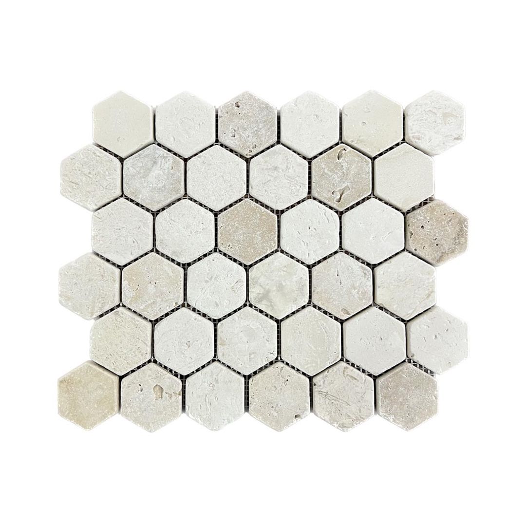 Sheet of rustic tumbled travertine hexagon mosaic showing softened edges and banded cream and brown stone