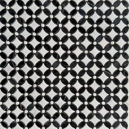 Close detail of polished Nero Marquina and Carrara petals meeting at a grout joint