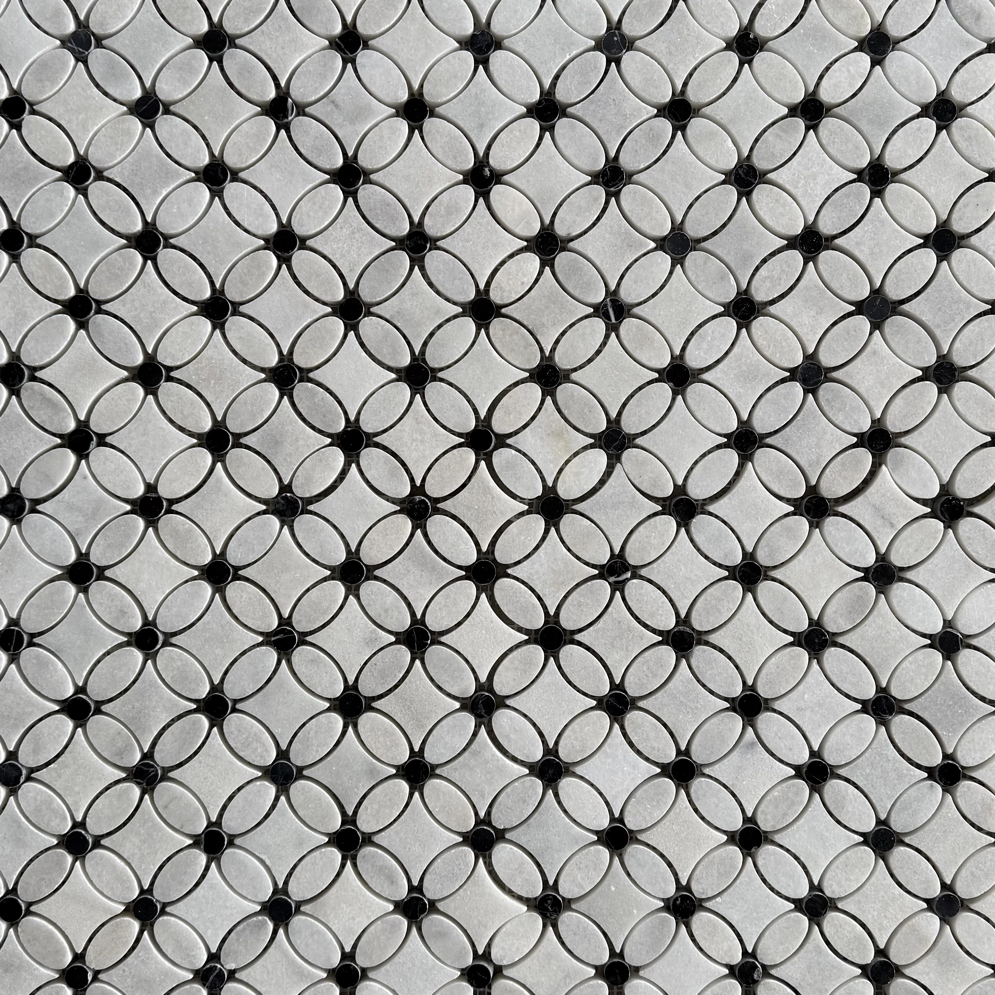 Close detail of a single Carrara marble flower with its polished black Nero Marquina centre