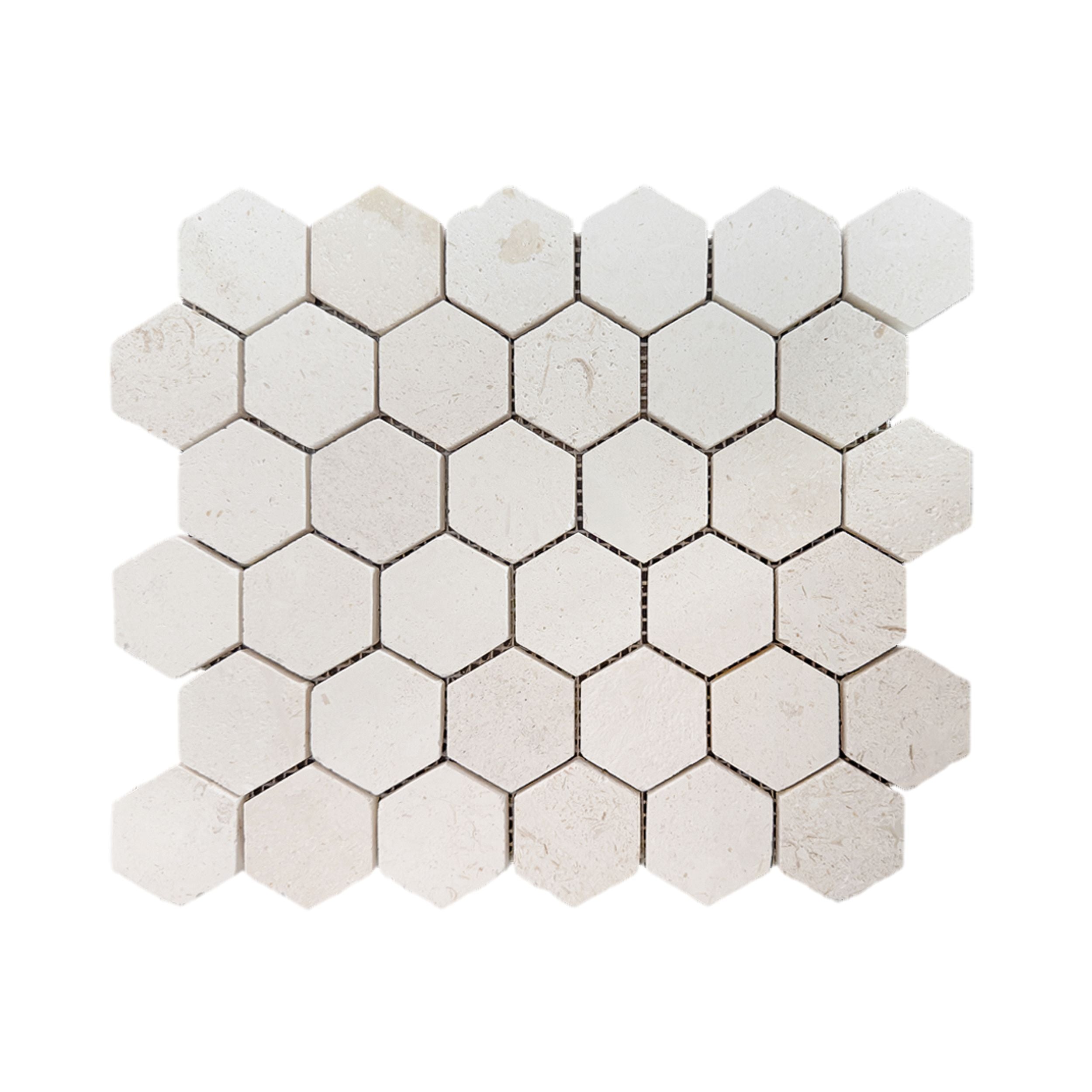 Close detail of honed Shellstone limestone hexagon mosaic showing fossil markings in the warm beige stone