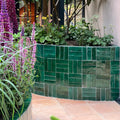 Medina moss green rectangle handmade moroccan zellige tile in emerald green glazed ceramic arranged in herringbone pattern on planter edge