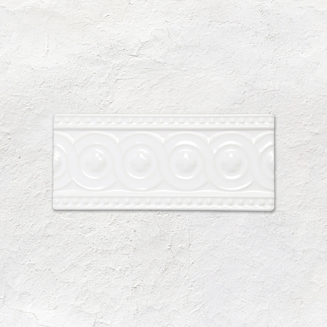 White rectangular ceramic baroque moulding helmingham tile with raised circular and beaded decorative patterns