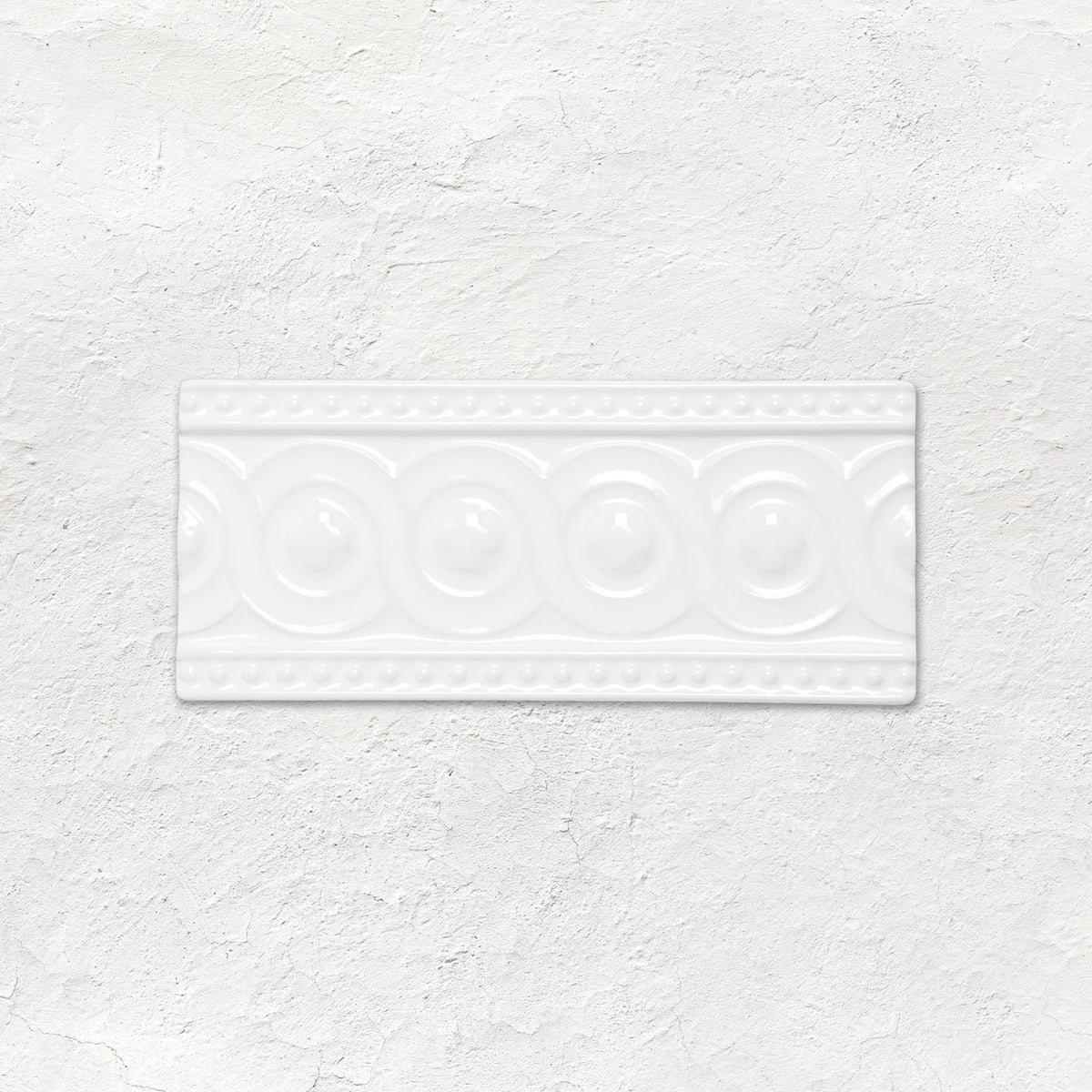 White rectangular ceramic baroque moulding helmingham tile with raised circular and beaded decorative patterns