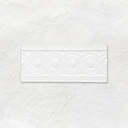 White rectangular ceramic baroque moulding helmingham tile with raised circular and beaded decorative patterns
