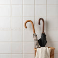 Beaulieu moulding helmingham two closed umbrellas with wooden handles in checkered and black patterns in wicker basket