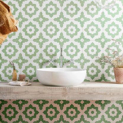 White ceramic vessel sink with sleek chrome faucet against bert and may green santona porcelain patterned tiles