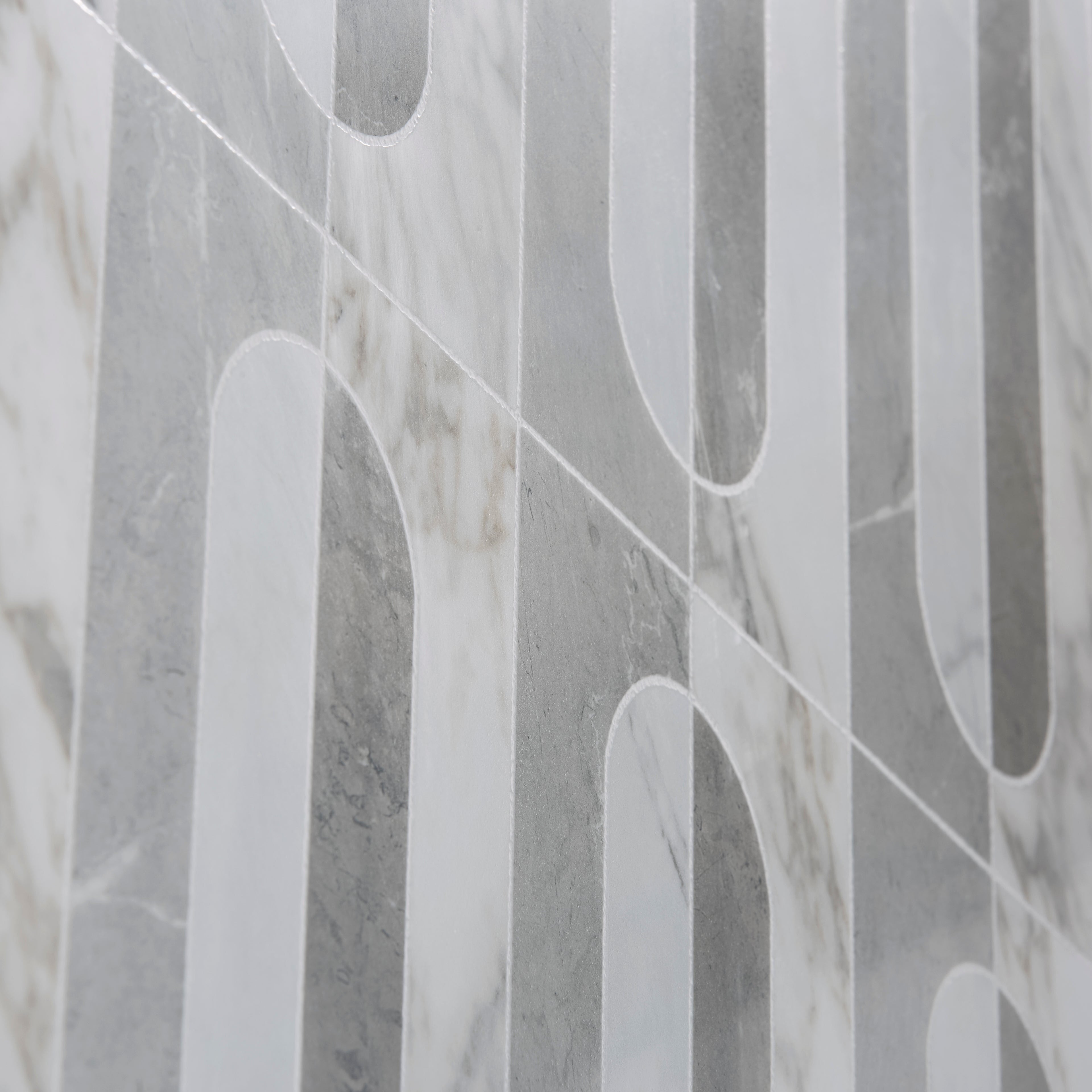 Byzantine porcelain palation sculpted gray and white marble-effect tiles with modern geometric vertical strips and arched cutouts