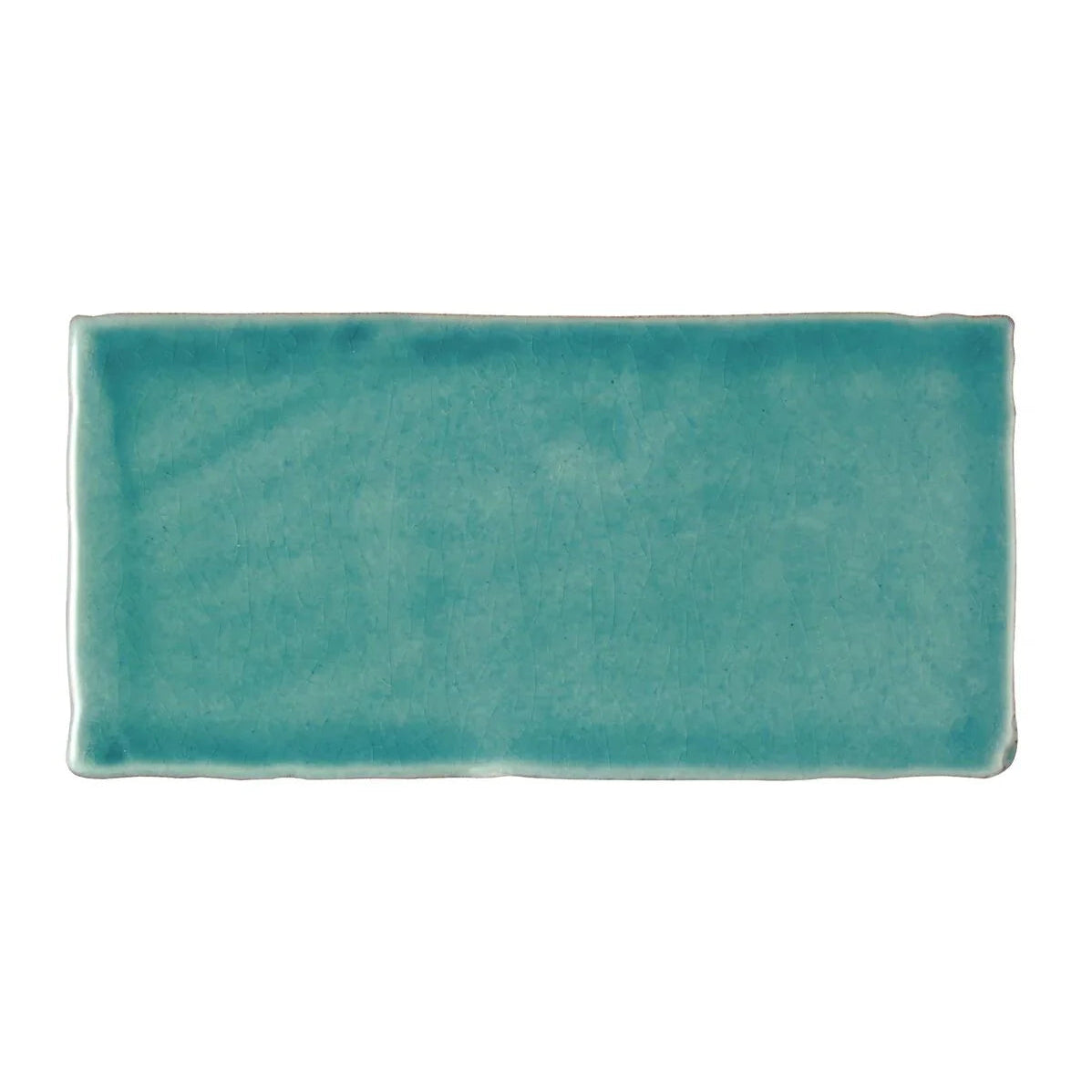 A rectangular ceramic Carnival Laredo blue glazed tile with matte turquoise finish and handcrafted edges