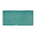 A rectangular ceramic Carnival Laredo blue glazed tile with matte turquoise finish and handcrafted edges