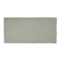 A rectangular matte finished ceramic tile in soft sage green with slightly irregular edges from Carnival Sella Grey Glazed Tile
