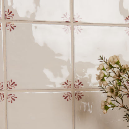 Decorative glass panel with floral patterns and a plant in the corner
