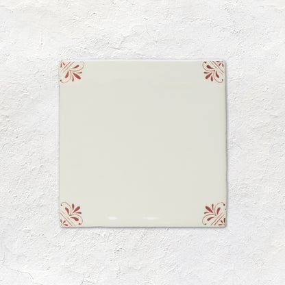 Rectangular ceramic tile with decorative patterns on a textured white background