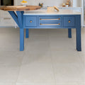 Blue kitchen island with white porcelain countertop and gold hardware in dorset porcelain white finish