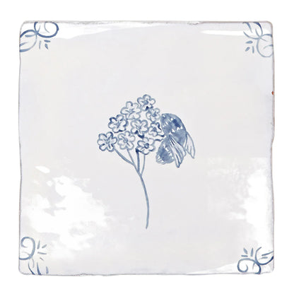 White ceramic tile with delicate blue hand-painted flowers and a bee English Delft bee blue gloss tile