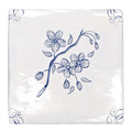 White ceramic coaster with delicate blue floral blossoms and buds on a branch english delft blossom blue gloss tile