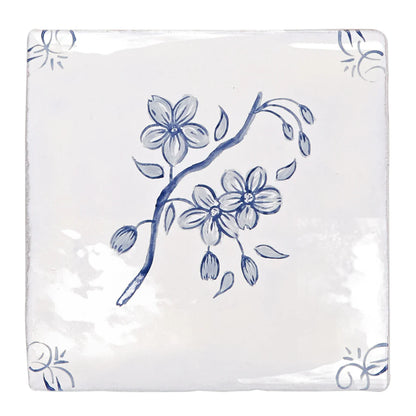 White ceramic coaster with delicate blue floral blossoms and buds on a branch english delft blossom blue gloss tile