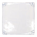 English delft blue gloss corner tile in white ceramic with delicate blue floral motifs in each corner
