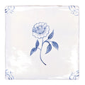 White ceramic coaster with delicate blue floral and decorative corner motifs from english delft peony blue gloss tile