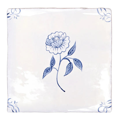 White ceramic coaster with delicate blue floral and decorative corner motifs from english delft peony blue gloss tile