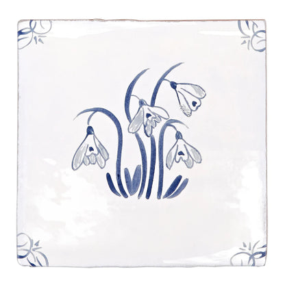White ceramic english delft snowdrop blue gloss tile with delicate hand-painted blue snowdrops and corner floral motifs