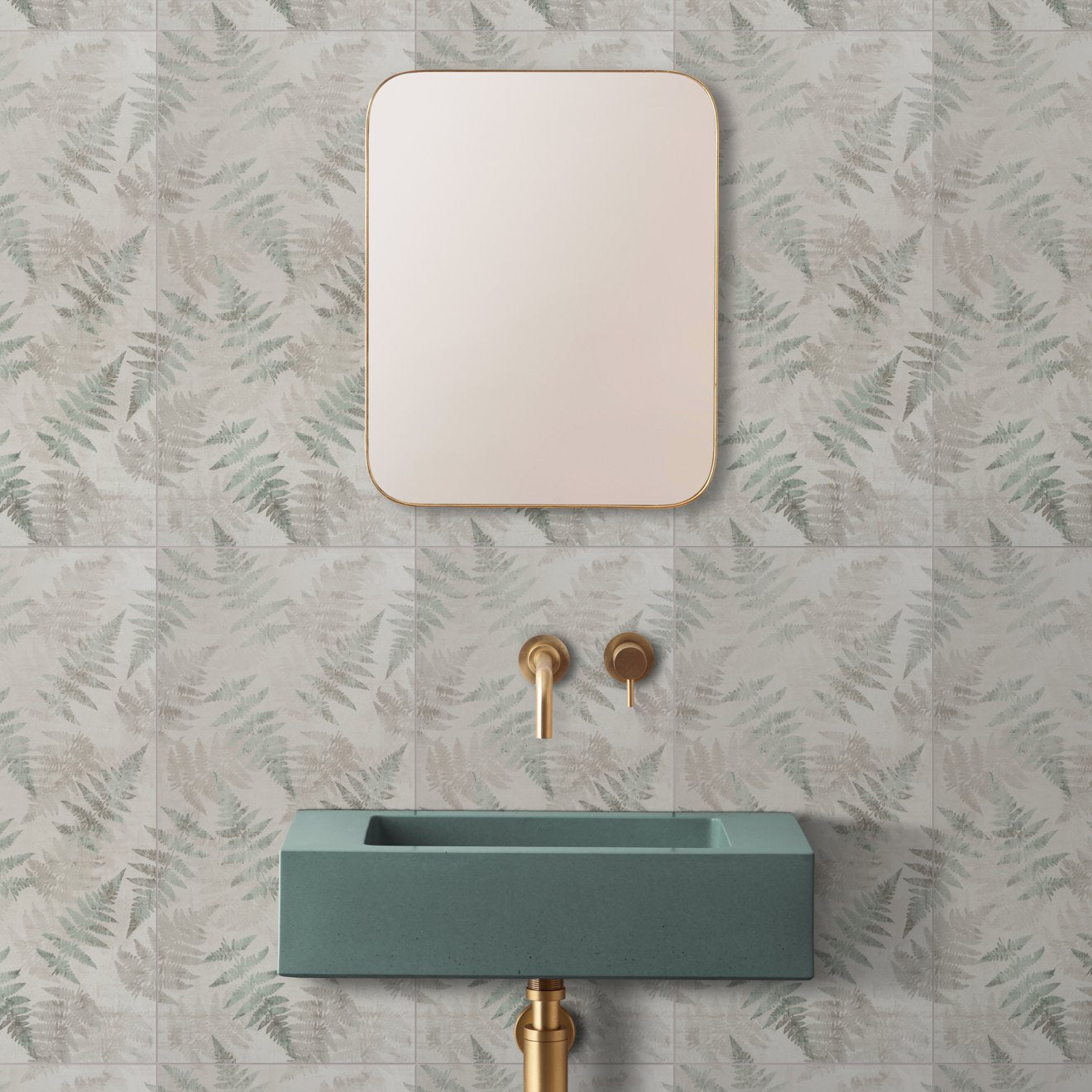 A rectangular eden glade mirror with a thin gold frame mounted above a teal concrete sink measuring 60x30cm