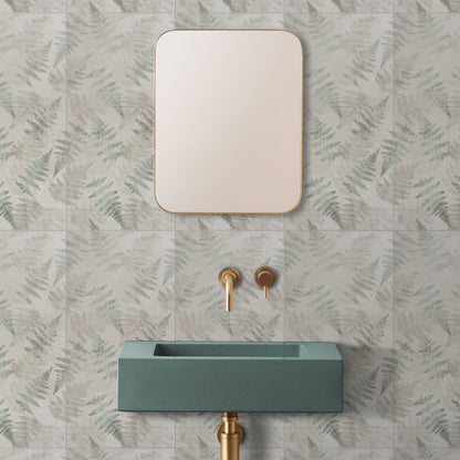 A rectangular eden glade mirror with a thin gold frame mounted above a teal concrete sink measuring 60x30cm